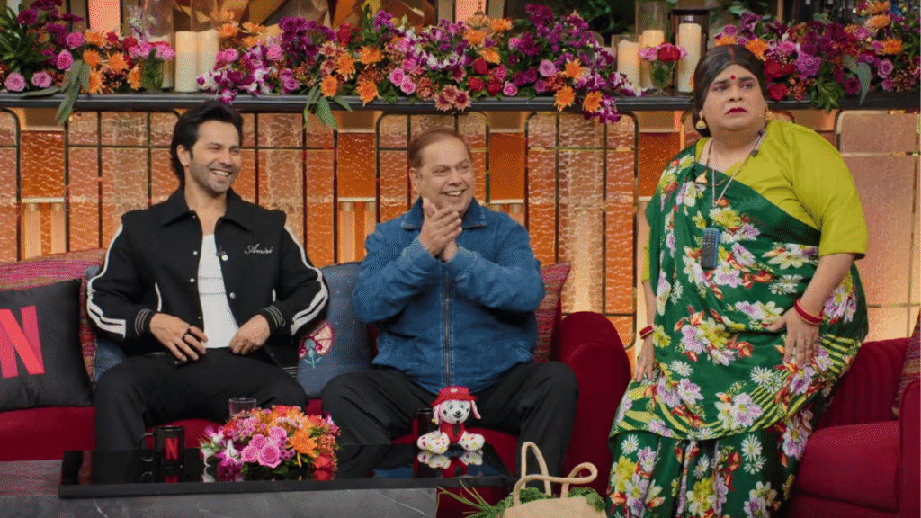 Varun Dhawan and David Dhawan laughing with Krushna Abhishek as Mona on The Great Indian Kapil Show Netflix