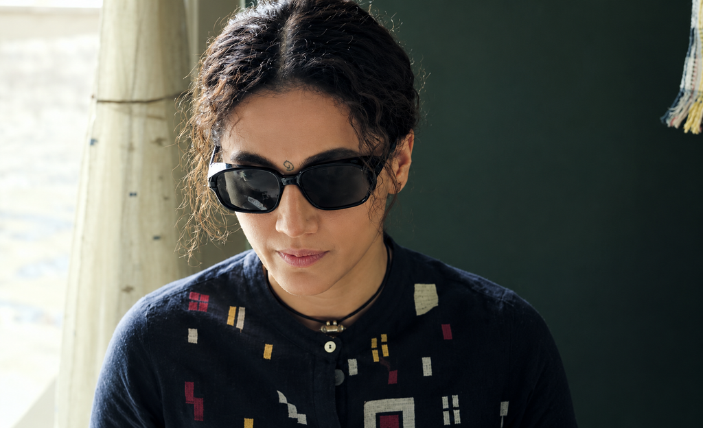 Taapsee Pannu as Bani wearing black sunglasses in an intense scene from the Netflix movie Gandhari (2026), as she searches for her kidnapped daughter.