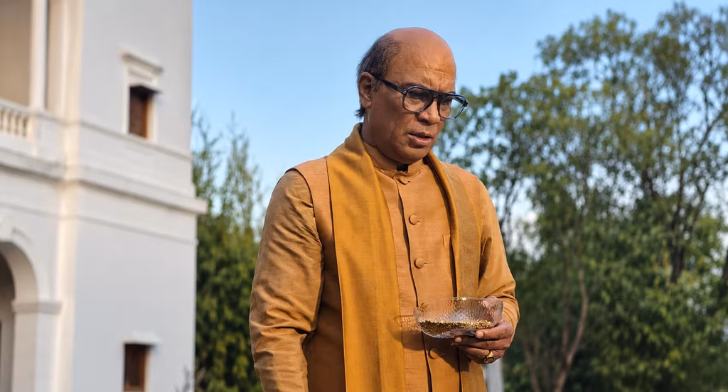 Vipin Sharma as PM Sudhakar Joshi holding a bowl outside a residence in a scene from Maharani Season 4.